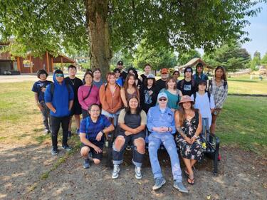 Group of Indigenous students sitting with Elder