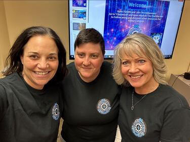 Three adults take a selfie