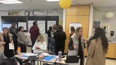 Group of educators gathered in a classroom learning about Sheltered Instruction Observation Protocol 