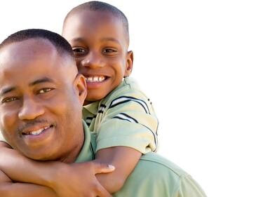 Adult male piggy backing boy both smiling